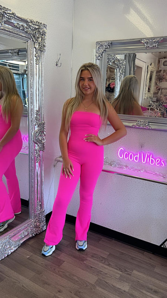 pink fine ribbed jumpsuit with flared bottoms and bandeaux style top